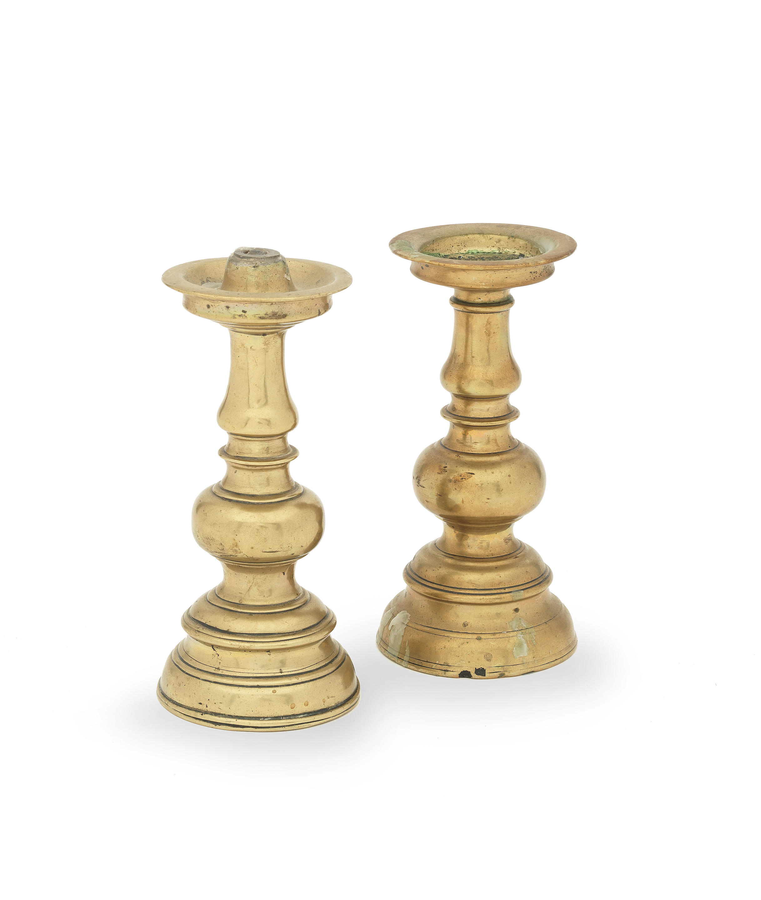 Two similar brass alloy pricket candlesticks, Flemish or German