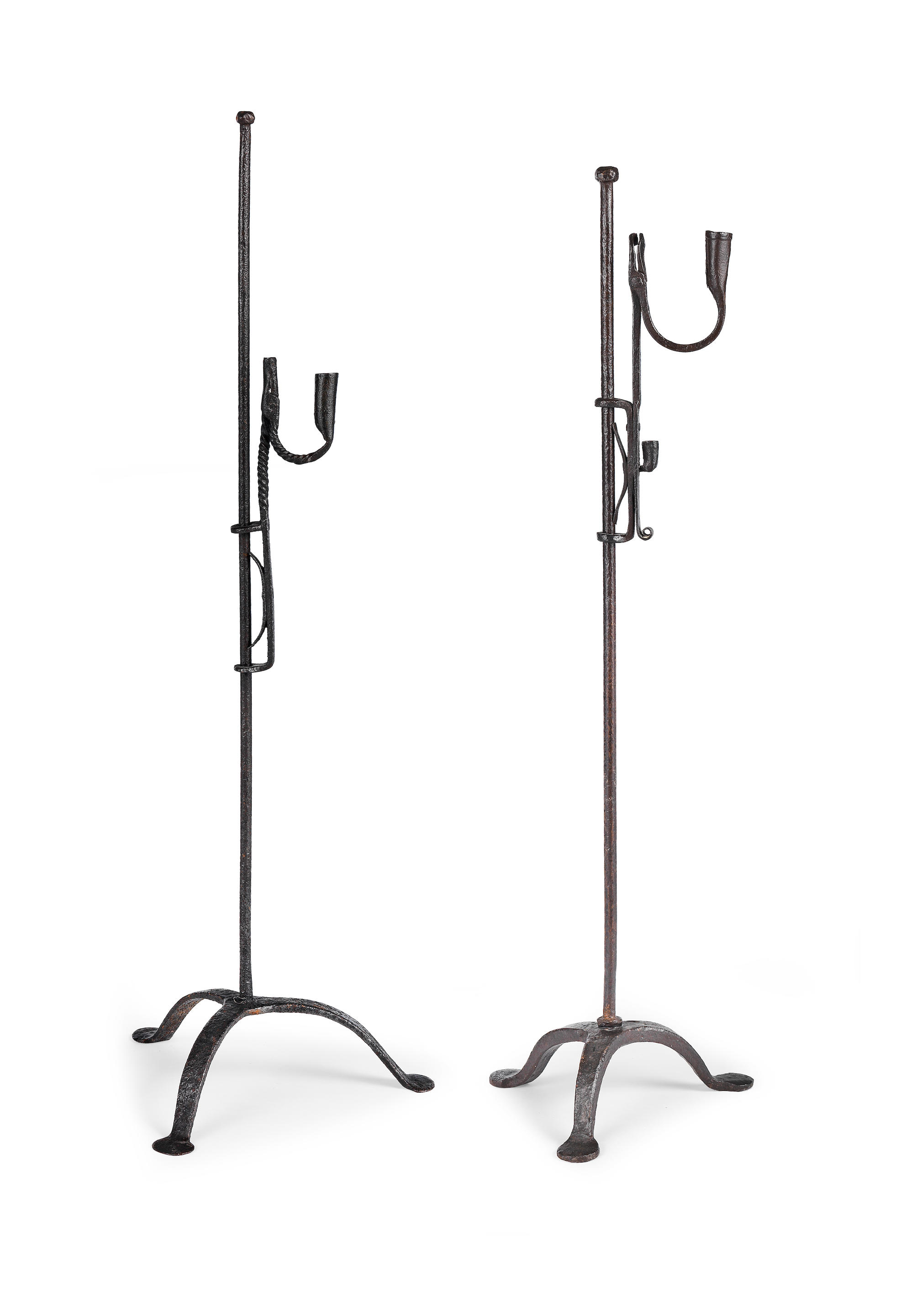 Two wrought iron standing rushlight and candle holders, Irish