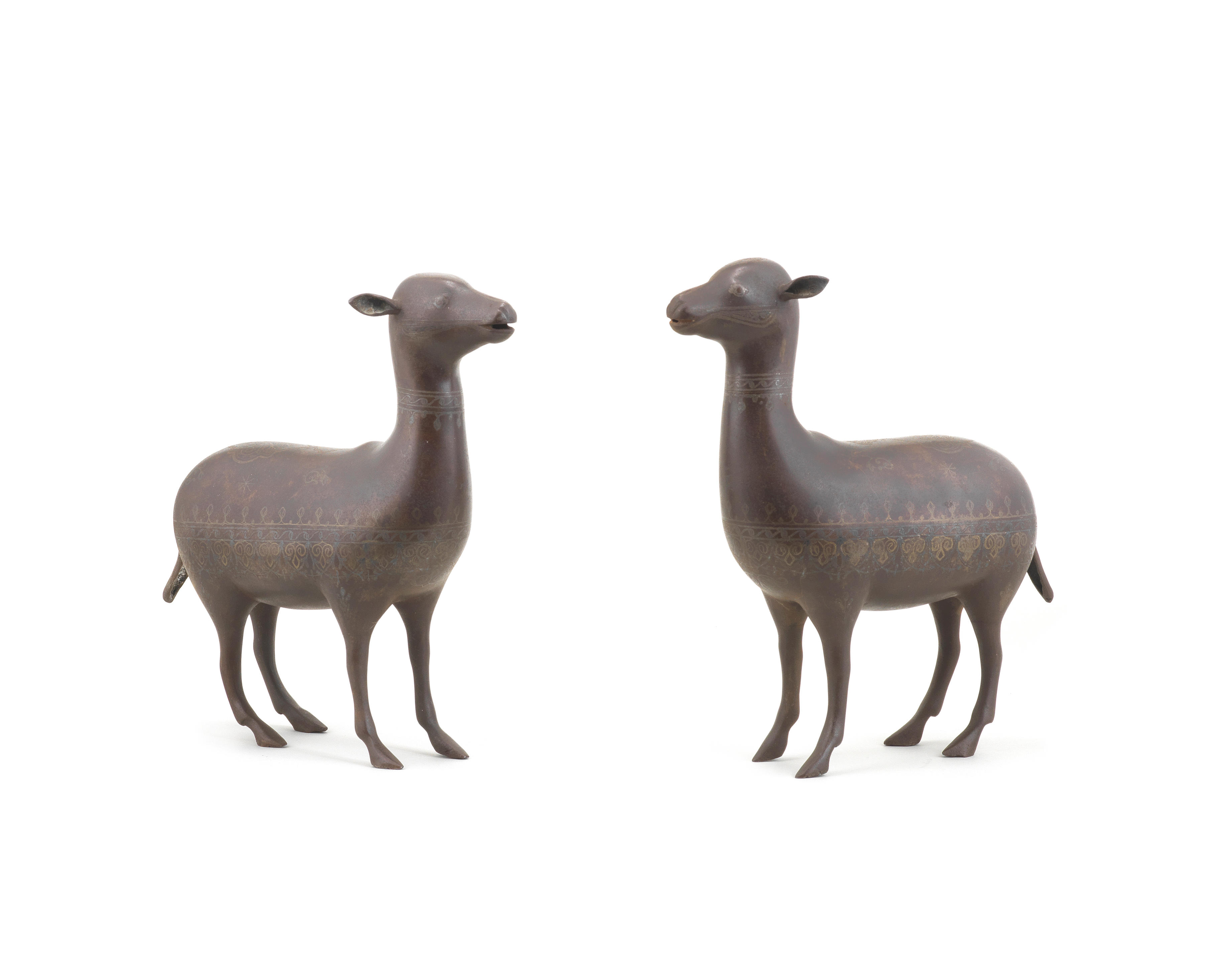A pair of Qajar silver-damascened steel sheep