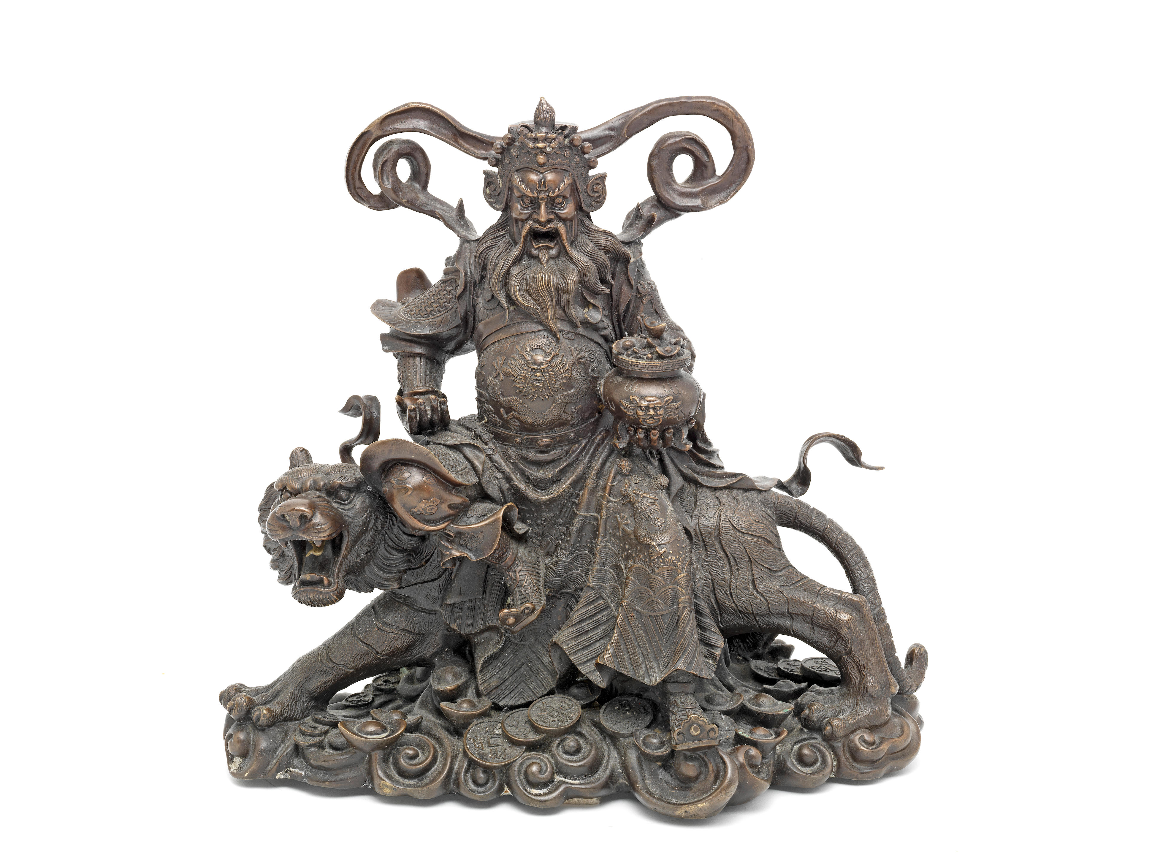 A late 19th / early 20th century Asian bronze model of a deity seated on a...