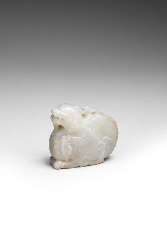 Bonhams : A RARE PALE GREEN JADE CARVING OF A MYTHICAL BEAST Ming Dynasty