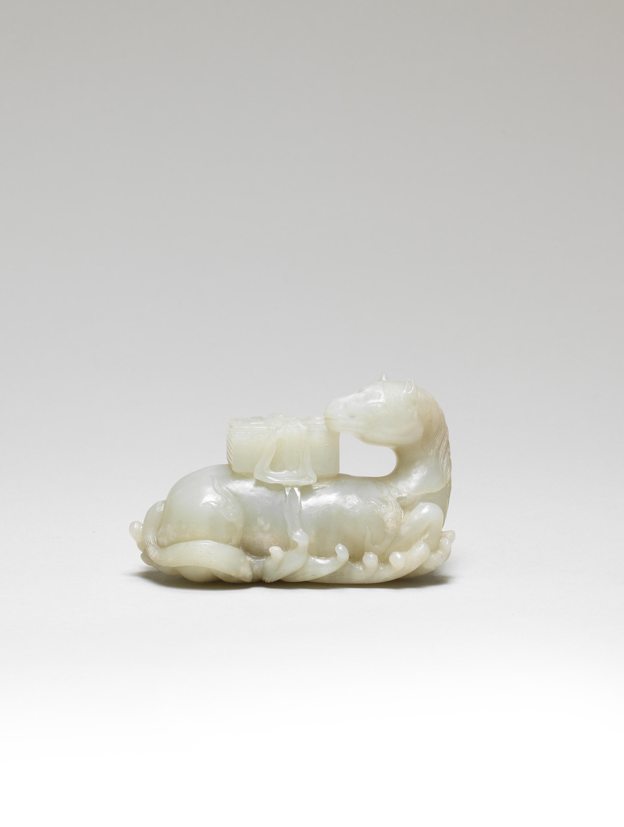 Bonhams : A PALE GREEN JADE CARVING OF A 'HEAVENLY HORSE' CARRYING ...