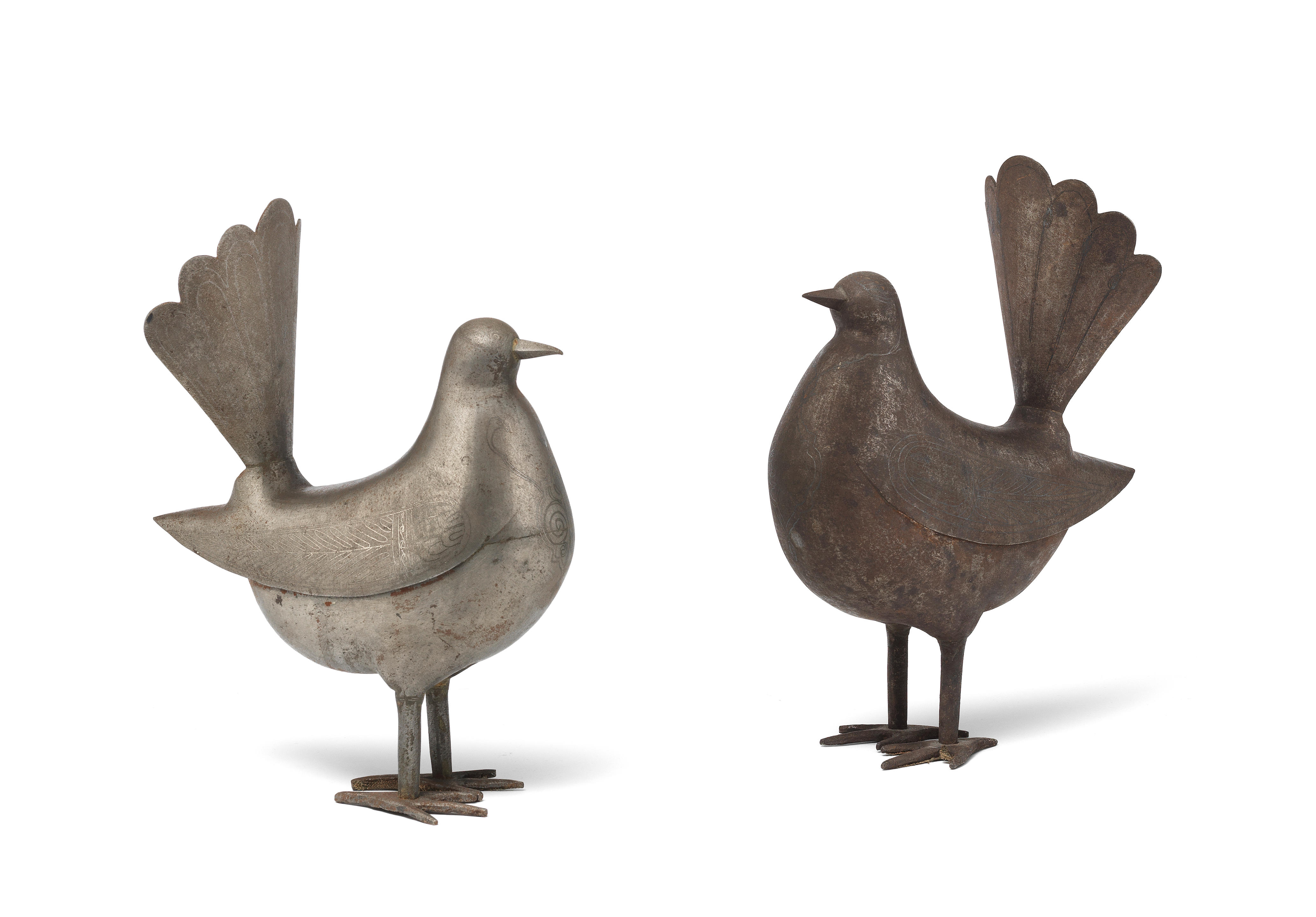 A pair of Qajar silver damascened steel birds