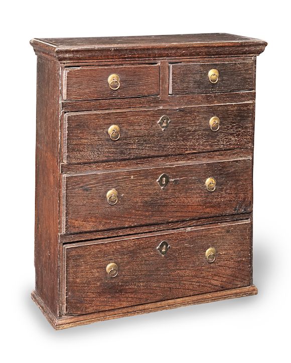 Bonhams A small Queen Anne oak 'tabletop' chest of drawers, circa 1710