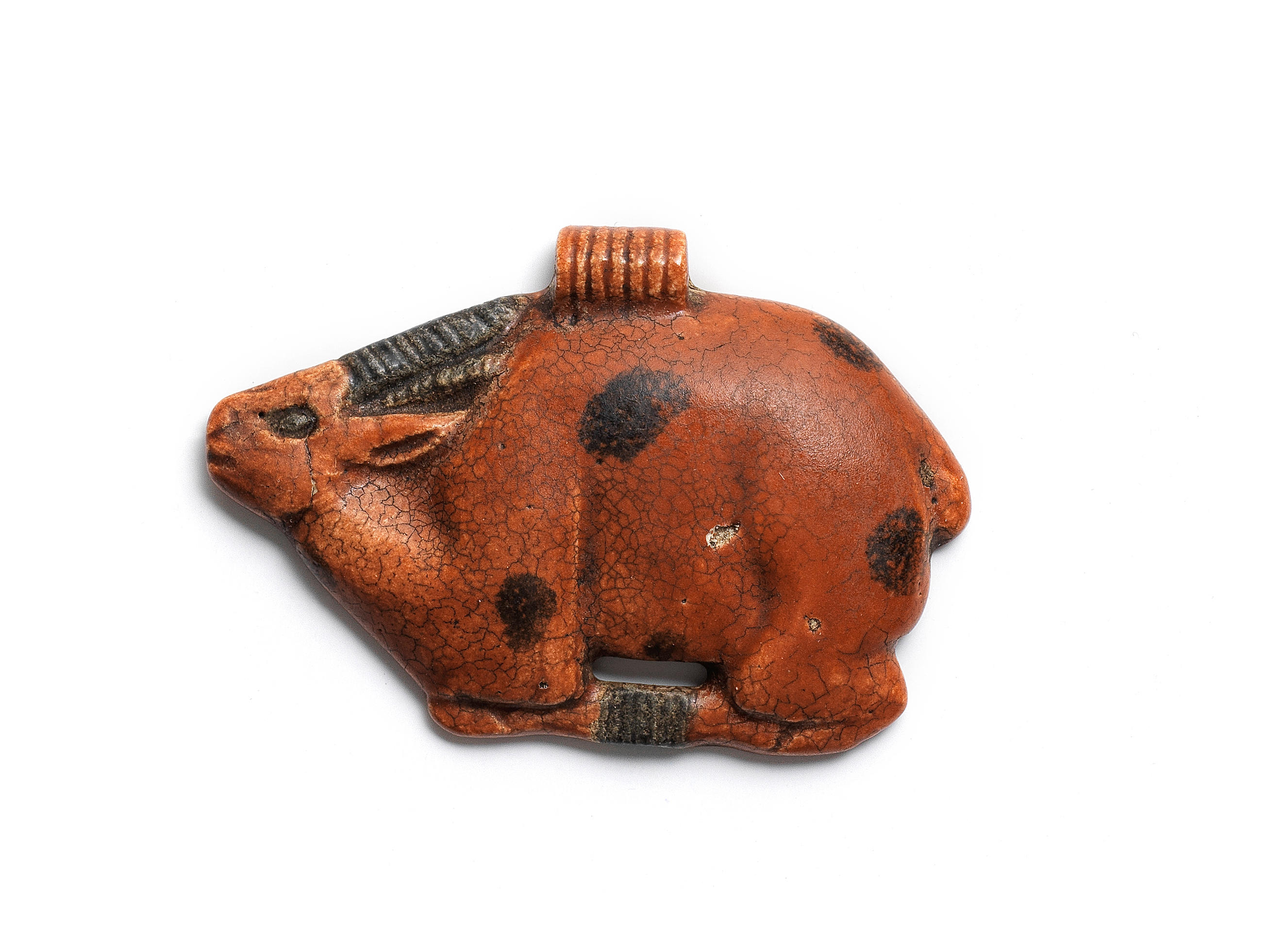 An Egyptian glazed composition amulet of an antelope