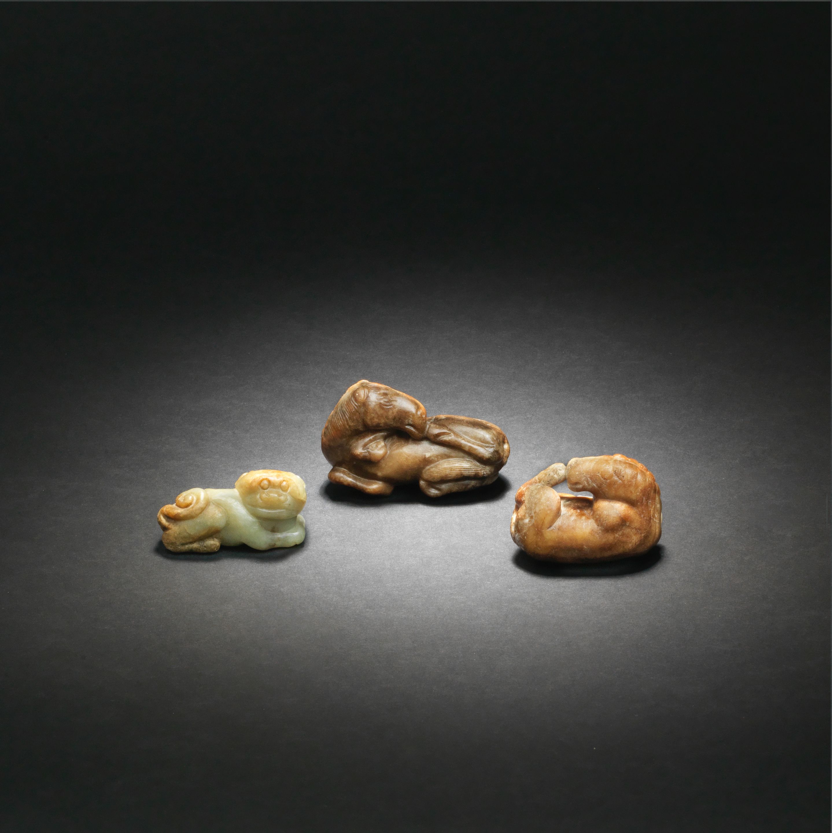 Bonhams TWO JADE CARVINGS OF HORSES AND A JADE CARVING OF A BUDDHIST