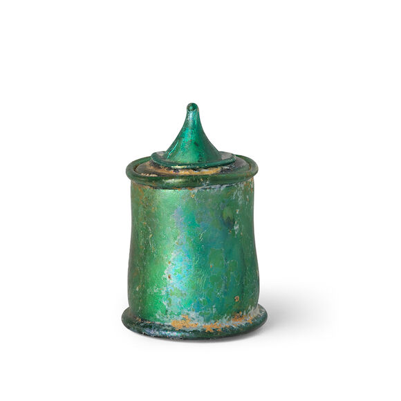 Bonhams : A Roman emerald green glass lidded pyxis