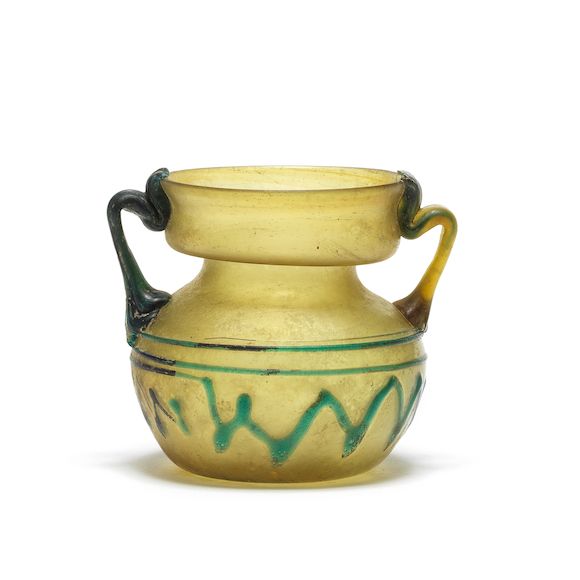 Bonhams A Roman yellow glass jar with turquoise trailing