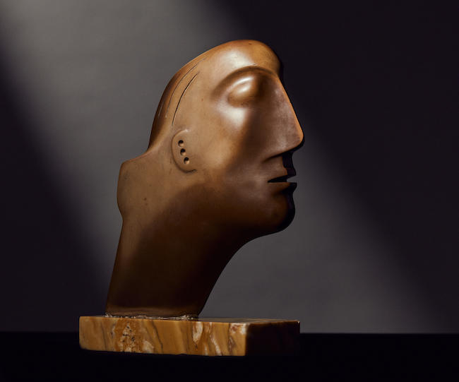 Henry Moore O.M., C.H.(British, 1898-1986)Head 17.7 cm. (7 in.) high (including the marble base) Carved in 1930