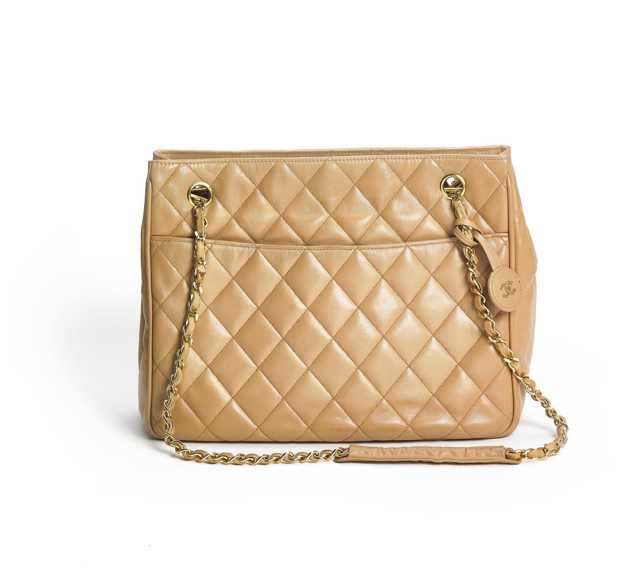 Bonhams : Chanel A Top Handle Flap Bag of beige coated canvas with gold  tone hardware, wooden top handle and wooden CC turn lock.