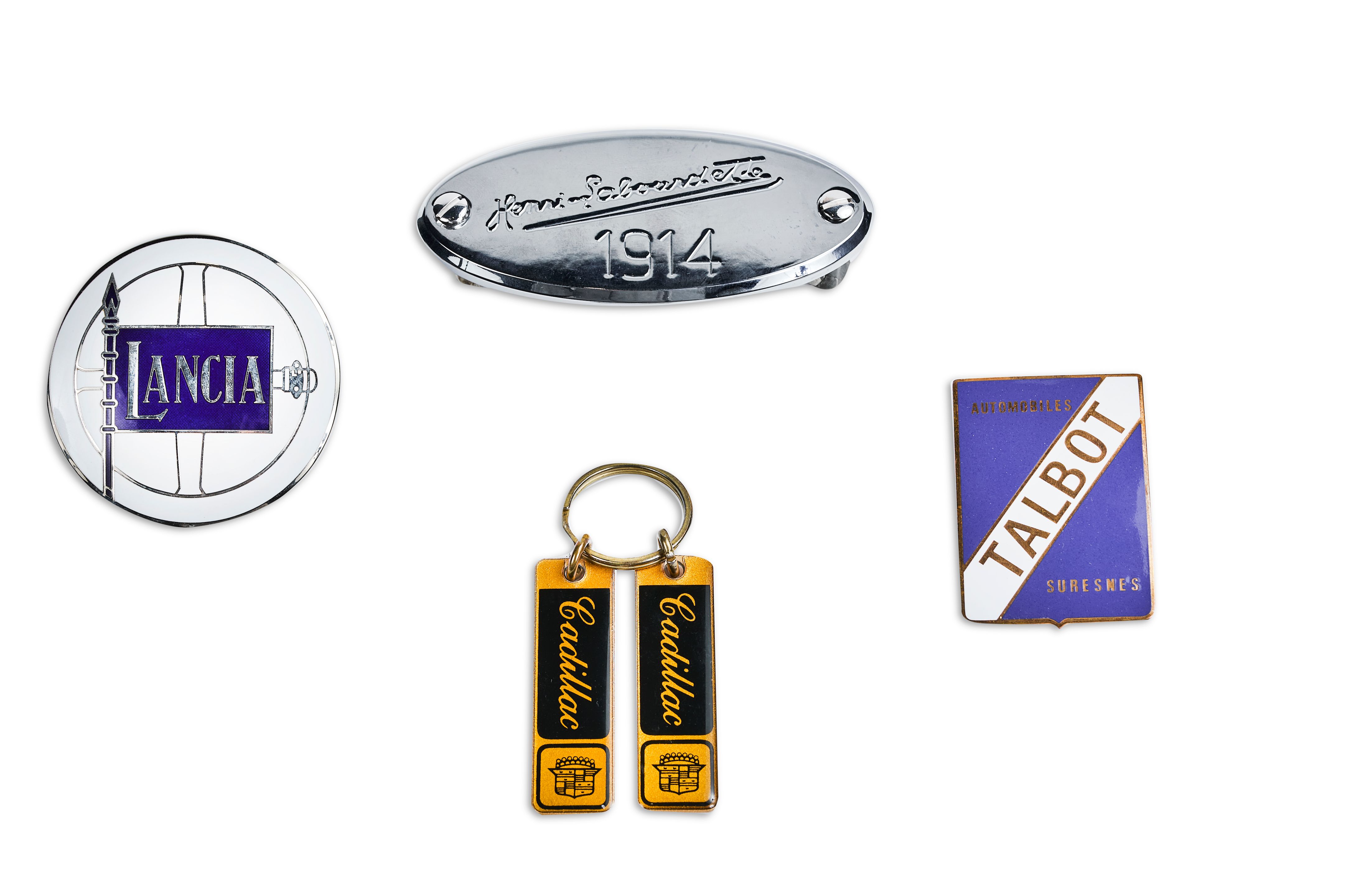 Bonhams Cars THREE AUTOMOTIVE GRILLE BADGES AND A KEY RING BADGES