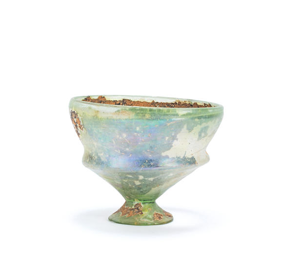 Bonhams : A Roman green glass footed carchesium