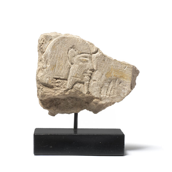 Bonhams : An Egyptian limestone relief fragment with the head of a Pharaoh