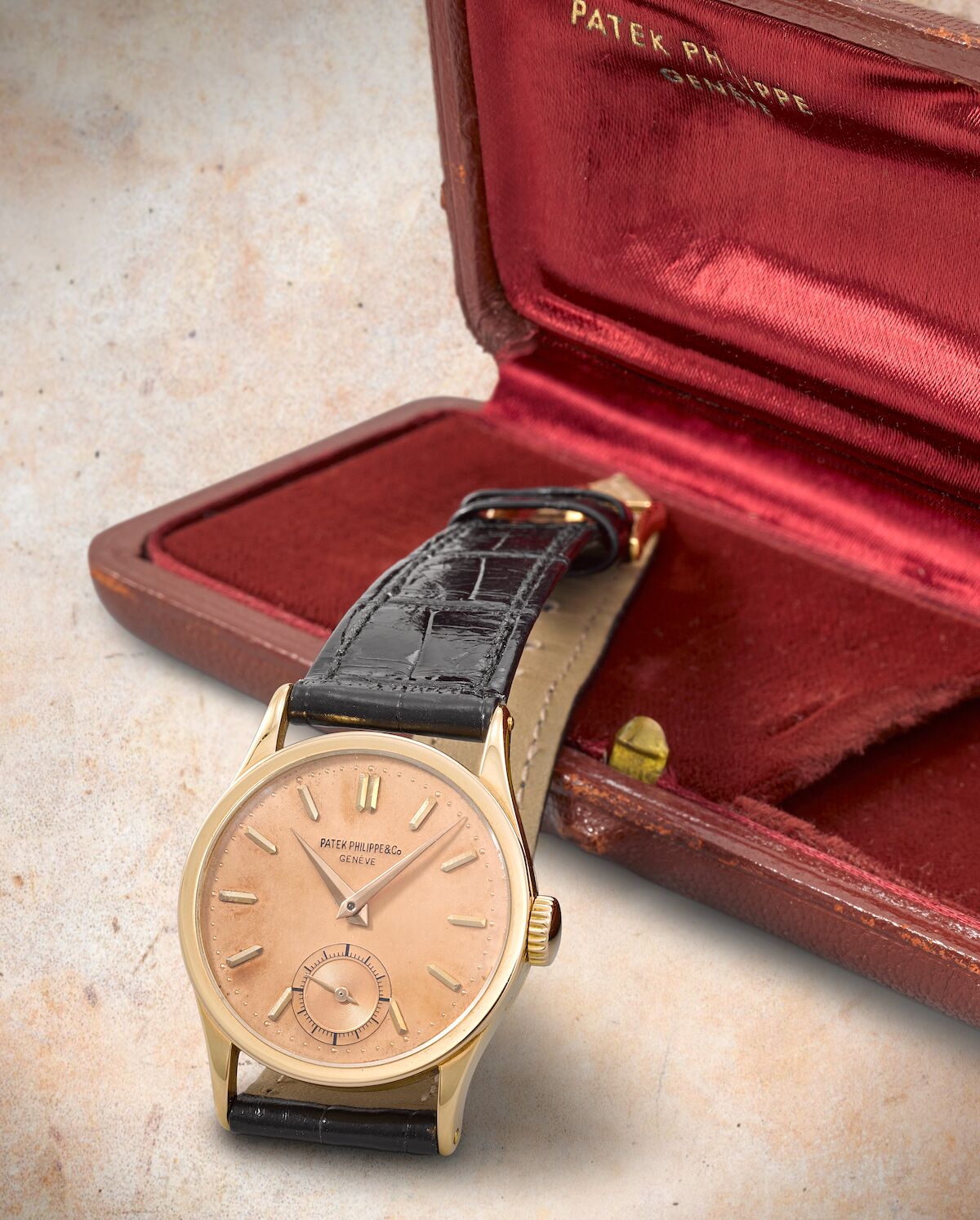 Rose-gold ref. 96 with salmon-pink dial, applied faceted rose-gold markers, lance hands and small seconds, shown with its Patek Philippe box. · Photo: Bonhams · © Bonhams, used with permission · Source: https://www.bonhams.com/auction/29155/lot/17/patek-philippe-a-fine-18k-rose-gold-pink-on-pink-manual-wind-wristwatch-calatrava-ref-96-sold-6th-november-1946/