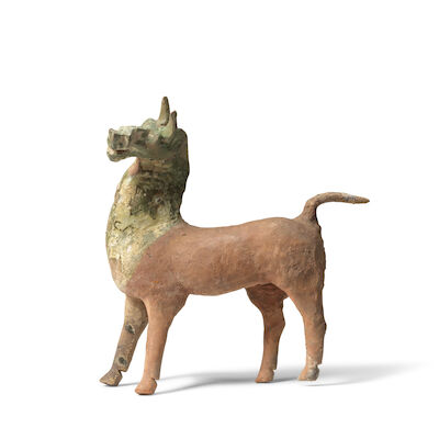 A PARTIALLY GREEN-GLAZED POTTERY MODEL OF A HORSE Han Dynasty