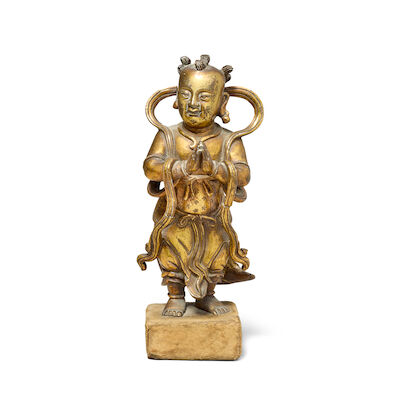 A GILT BRONZE FIGURE OF AN ACOLYTE 17th century