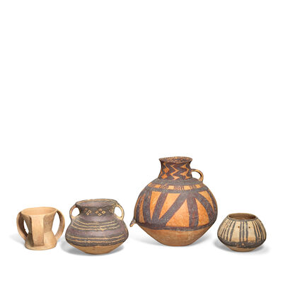 FOUR RED POTTERY VESSELS INCLUDING A RARE THREE HANDLED QIJIA CUP Neolithic, Majiayao culture (c.3300-2000 BC) and Qijia culture (c.2050-1700 BC) (4)