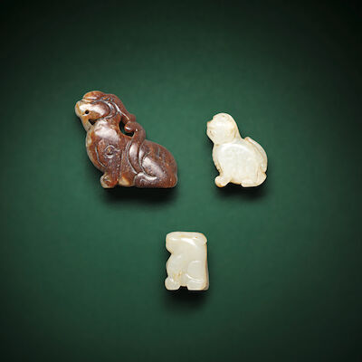 A GROUP OF THREE PALE GREEN AND RUSSET JADE BIXIE CARVINGS Song/Ming Dynasty and later (3)