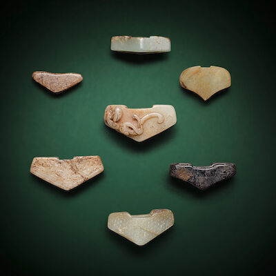 A GROUP OF SEVEN JADE SWORD GUARDS Possibly Han Dynasty and later (7)