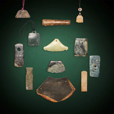 A GROUP OF TWELVE JADE FITTINGS AND PLAQUES Probably Neolithic period and later (12)