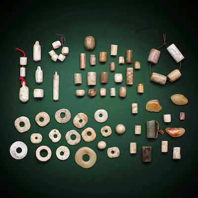 A GROUP OF JADE DISCS, AWL-SHAPED ORNAMENTS, TUBES AND BEADS Neolithic period and later (56)