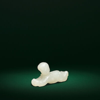 A RARE WHITE JADE CARVING OF A RECUMBENT BOY Song/Ming Dynasty