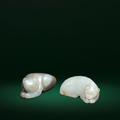 TWO PALE GREEN AND BROWN JADE RECUMBENT CAT CARVINGS Qing Dynasty (2)