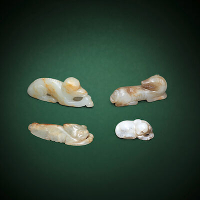 A GROUP OF FOUR RECUMBENT HOUND CARVINGS Probably Song Dynasty and later (4)