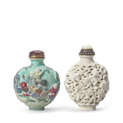 A WHITE-GLAZED RETICULATED 'BUDDHIST LIONS' SNUFF BOTTLE AND A FAMILLE ROSE MOULDED 'LUOHAN' SNUFF BOTTLE The 'luohan' bottle with a Qianlong six-character mark, 1780-1850 (4)