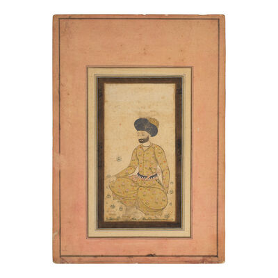 A seated nobleman, dressed in a gold robe, a jambiyya in his belt Persia, Isfahan, 17th Century
