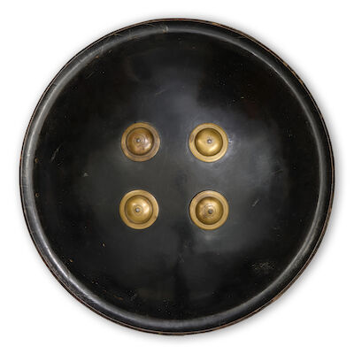 A Mughal lacquered-hide shield (dhal) with brass mounts North India, 18th Century