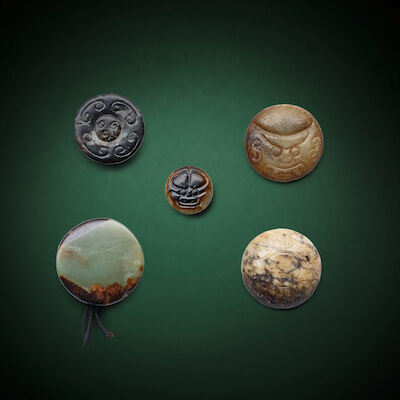 A GROUP OF FOUR JADE SWORD POMMELS AND A SMALL 'BEAST-MASK' PENDANT Song/Ming Dynasty (5)