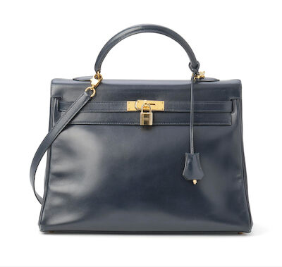 Hermès: A "Kelly Retourne 35" bag of navy blue Box leather with gold tone hardware. 1994.