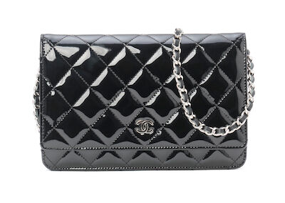 Chanel: A "Wallet on a chain" of black quilted patent leather with silver tone hardware and shoulder strap. 2010-2011.