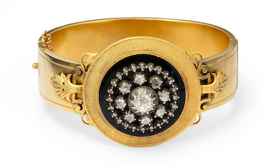 Victorian bangle of 14k gold and silver set with numerous rose-cut diamonds and black enamel. Circa 1870.