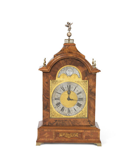 A George II musical clock in a walnut case. The dial and movement signed Parton, London. England, c. 1740. H. 64 cm. W. 33 cm. D. 18 cm.