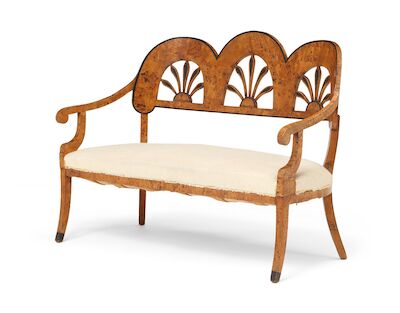 An Austrian Late Empire sofa of stained rootwood and birchwood, curved back with three pierced palmettes. Early 19th century. H. 102 cm. W. 140 cm. D. 60 cm.