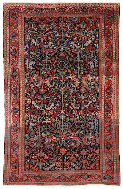 A Heriz carpet, North West Persia. All over stylized branches on a blue field. First half 20th century. 355 x 230 cm.