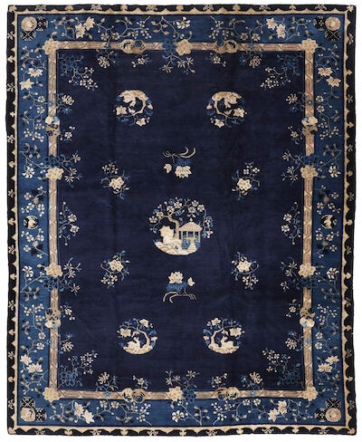 A Peking carpet, China. Central medallion with pagoda on an open blue field with flower vines. Early 20th century. 350 x 280 cm.