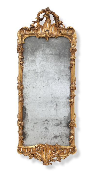 A German Rococo mirror in a giltwood frame. Mid-18th century. H. 144 cm. W. 55 cm.