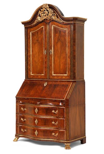 A Danish Rococo walnut and giltwood bureau cabinet. Mid-18th century. H. 257 cm. W. 127 cm. D. 62 cm.