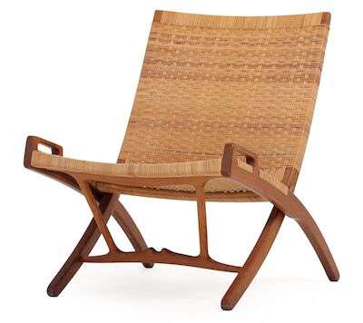 Hans J. Wegner: "JH 512". A patinated oak folding chair, seat and back with woven cane. "JH 512". A patinated oak folding chair, seat and back with woven cane. Model JH 512. Designed 1949. This example made 1950s by cabinetmaker Johannes Hansen, stamped.