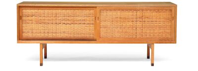 Hans J. Wegner: "RY 26". Oak sideboard with rosewood "shoes". Front with two sliding doors with woven cane. Manufactured by Ry Møbler. "RY 26". Oak sideboard with rosewood "shoes". Front with two sliding doors with woven cane, behind which trays and shelves. This example manufactured 1960s by Ry Møb