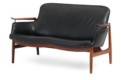 Finn Juhl: "FJ 53". Freestanding two seater Brazilian rosewood sofa with "floating" armrests. "FJ 53". Freestanding two seater Brazilian rosewood sofa with "floating" armrests on brass fittings. Sides, seat and back upholstered with black leather. Designed 1953. Made 1950-1960s by cabinetmaker Niels