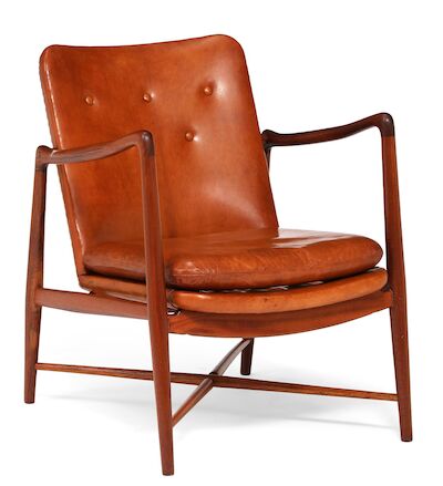 Finn Juhl: "Fireplace Chair". A teak easy chair with cross-stretchers below seat. Upholstered with patinated Niger leather. "Fireplace Chair". A teak easy chair with cross-stretchers below seat. Seat, back and loose seat cushion upholstered with patinated Niger leather, back fitted with buttons. Mod