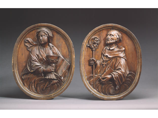 A pair of Italian walnut Reliefs of St. Bonaventura and St. Paul, 17th century, 50cms x 40cms