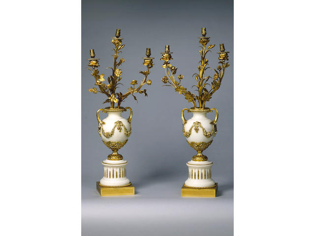 A pair of gilt metal rococo style candelabra (2)