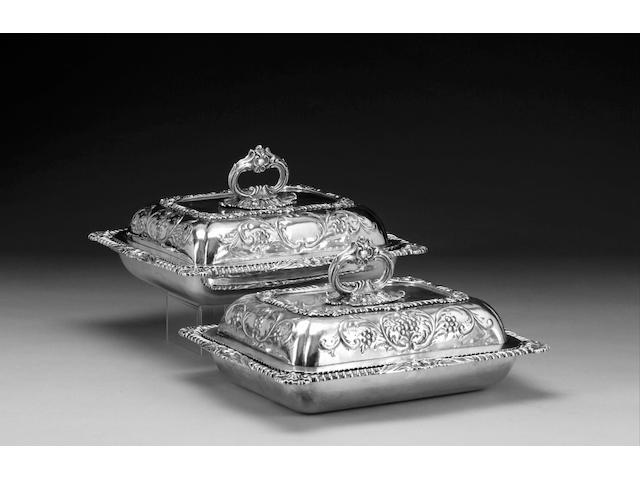 A matching pair of George IV silver entr&#233;e dishes and covers, by John Houle, London one 1825 the other with a top hallmarked for London 1824 with date letter rubbed on base,