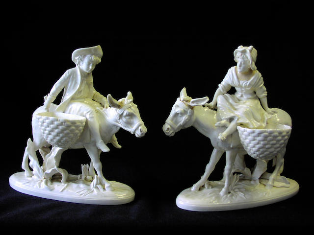A pair of Moore white glazed porcelain figural sweetmeats,