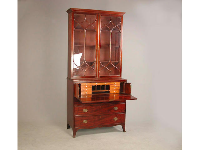 A late George III mahogany and crossbanded secretaire bookcase 108cm. wide, 55cm. wide, 239cm. high.